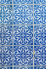 Detail of traditional portuguese tiles pattern with blue ornaments. Detail of traditional tiles from the facade of an old house in Porto, Portugal. Traditional Portugal pottery. Multicolor design.