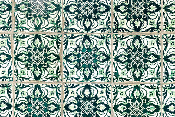 Detail of traditional portuguese tiles pattern with green ornaments. Detail of traditional tiles from the facade of an old house in Porto, Portugal. Traditional Portugal pottery. Multicolor design.