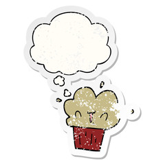 cartoon cupcake and thought bubble as a distressed worn sticker
