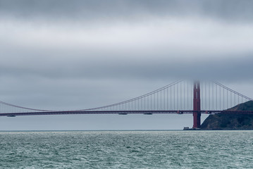 View of Golden Gate Bridge from a boat on a foggy day