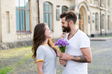 Naklejka premium True feelings. Pick up girl for date. Bearded hipster fall in love. Couple meeting for date. Bouquet gift. Man giving flower bouquet. Romantic date. Guy prepared surprise bouquet for girlfriend