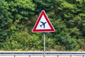 airplanes crossing street sign