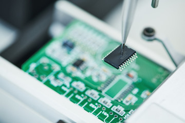 microchip semiconductor manufacturing. automatic machine robot installing chip on board.