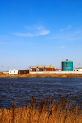 Fototapeta premium Oil storage tanks and pond