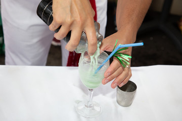 Fototapeta na wymiar man bartender prepares a cocktail in the bar