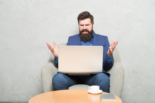 Having Some Problems At Work. Hipster Drinking Coffee And Working On Computer Work Station. Bearded Man Doing His Work Online. Working Globally Through Distance Work