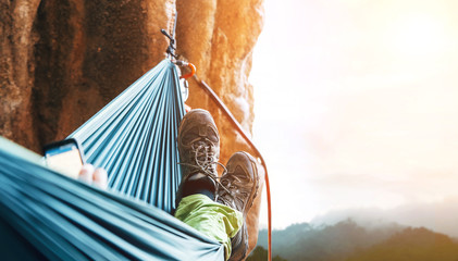 Climber rest in hammok on the cliff wall
