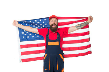USA flag is flown higher than the others. Bearded man holding american flag on independence day. Patriotic worker celebrating flag day. Happy hipster in workwear with national flag of united states