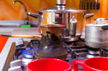 part of kitchen interior - shelves with glass doors, gas stove, dishes, close up