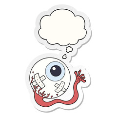 cartoon injured eyeball and thought bubble as a printed sticker