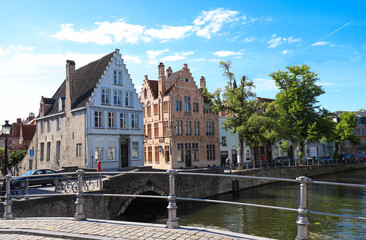 Scenic city view of Bruges canal with beautiful medieval colored houses and reflections.