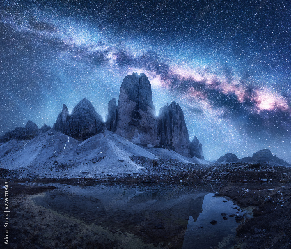 Wall mural milky way over mountains at night in summer. colorful landscape with alpine mountains, lake, blue sk