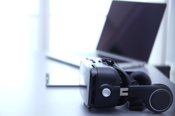 Fototapeta na wymiar Virtual reality goggles on desk with laptop. business. 3d technology