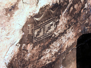 The petro glyphs or etchings on rocks by people who lived in the area. The etchings made using a hard object on the rock surface layered with a coating of dust or the desert patina.