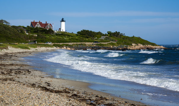 heavy surf at the ocean shore with a view of Nobska Light lighthouse