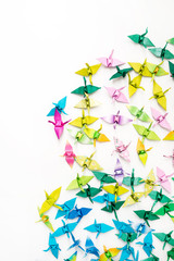Colorful paper birds on white background.