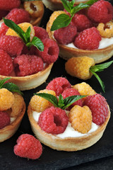 Tartlets with red and yellow raspberries. Keto diet. Keto dessert