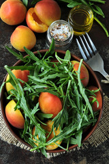Healthy arugula salad apricot. Summer delicious diet salad. Keto diet salad.