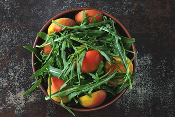 Healthy arugula salad apricot. Summer delicious diet salad. Keto diet salad.