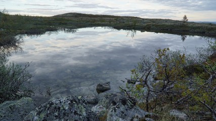 The sky is reflected in the alpine lake.