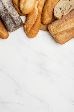 Breads at upper edge on white background