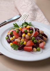 Healthy bean and corn salad on a white plate