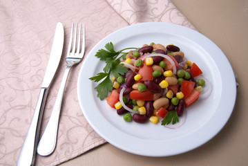 Healthy bean and corn salad on a white plate