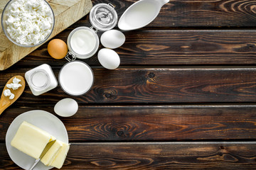 Eggs, butter, milk, yougurt, cottage for natural farm products yougurt on wooden background top view copyspace