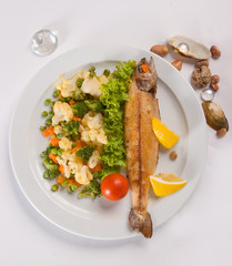 grilled fish with vegetables on a white background