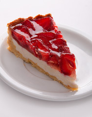 delicate strawberry cheesecake on a white plate. macro