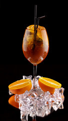alcohol cocktail on a black background with fresh summer fruits and ice cubes - 276017587