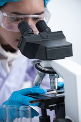 Scientists are using microscopes. For laboratory experiments
