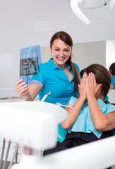 Obraz premium Frustrated patient at the dentist, the doctor gives advice about the poor condition of the teeth.