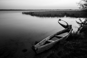 A canoe on the shore of the lake. A moody landscape. Liutsymer Lake. Polesie. Ukraine