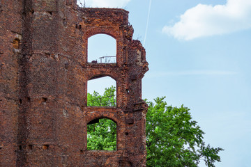 Ruins from an old brick building against the sky. Empty windows