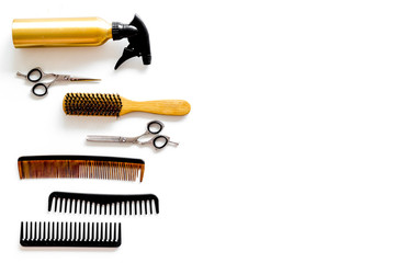 Hairdresser equipment for cutting hair and styling with combs, sciccors, brushes on white background top view copyspace