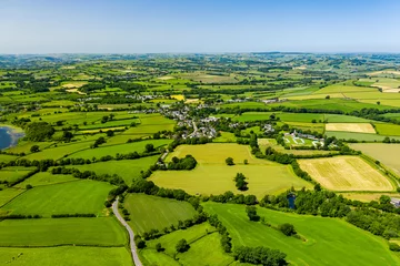 Keuken spatwand met foto Aerial drone view of green fields and farmland in rural Wales © whitcomberd