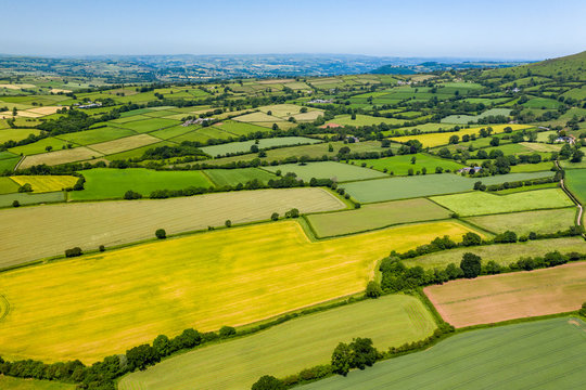 Aerial drone view of green fields and farmland in rural Wales