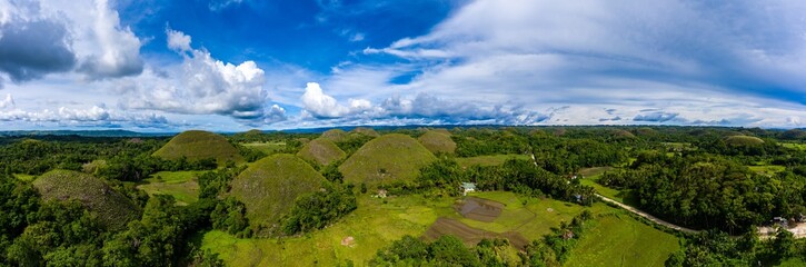 Aerial panorama of storm clouds behind the unique Chocolate Hills landscape in Bohol,Philippines