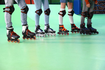 Family spending time at roller skating rink, closeup