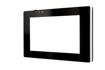 touchscreen tablet with a blank white screen and a black case mounted on a white wall to control smart home technology, close-up side view.