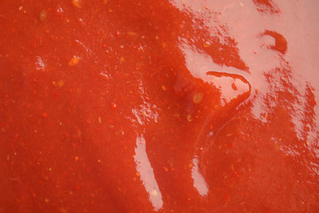 Fresh tasty tomato sauce as background, closeup