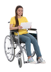Young woman in wheelchair using tablet isolated on white