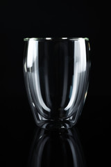 Empty double wall glass on black background