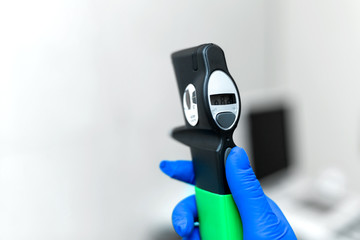 Professional equipment ophthalmologist tonometer..Doctor vet holds in his hand with a glove...
