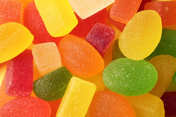 Tasty colorful jelly candies as background, top view