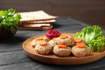 Plate of traditional Passover (Pesach) gefilte fish on wooden table