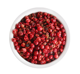 Bowl of red peppercorns isolated on white, top view