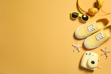 Flat lay composition with sunglasses and camera on color background, space for text. Beach...