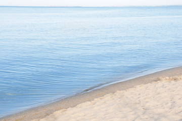 Fototapeta na wymiar Sandy beach near sea on sunny day